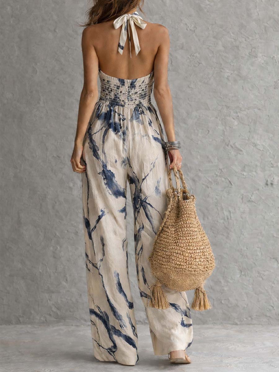Mono largo con escote halter, estampado efecto tinta degradada, pierna ancha y prácticos bolsillos